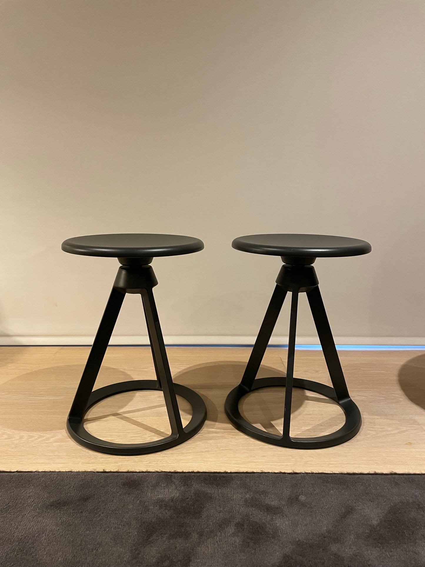 A pair of Edward Barber and Jay Osgerby for Knoll Piton swivel stools in black  steel